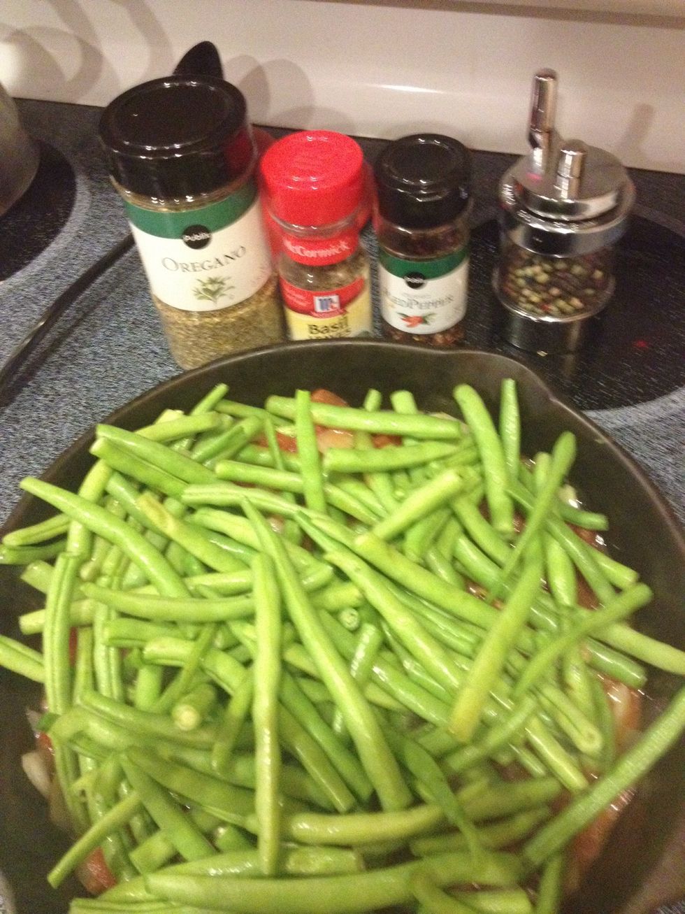 Add canned tomatoes, green beans, herbs, spices and garlic. Add olives if you chose to. (Olive Are great in this. I just didn't have any today!)