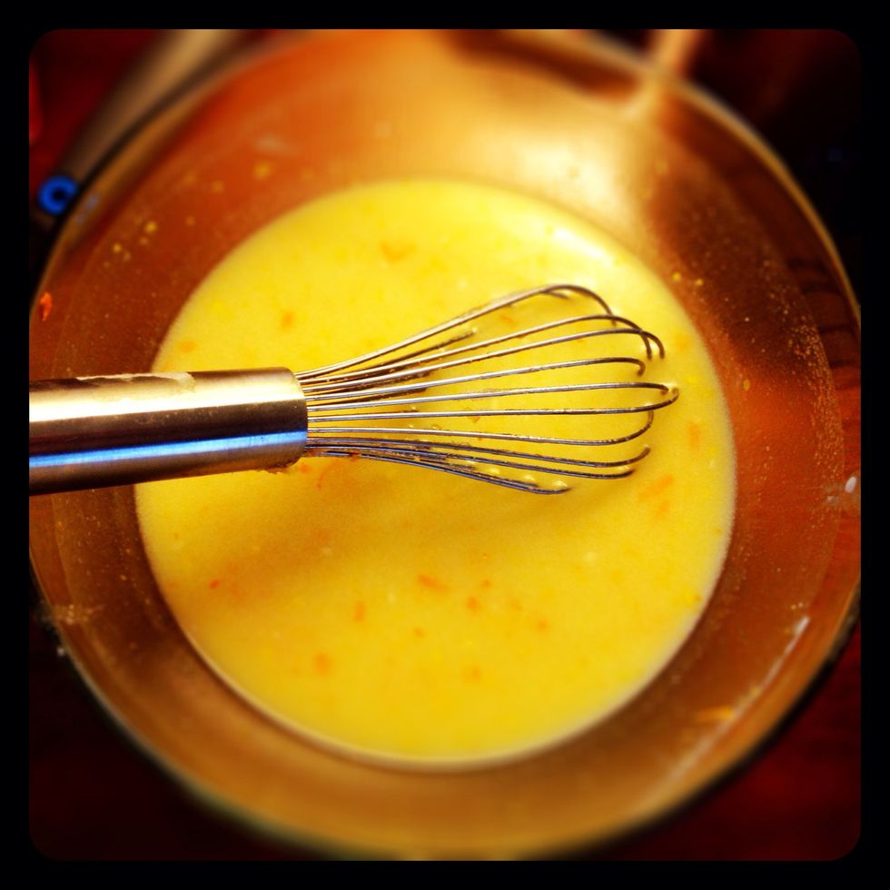 Add canola oil, sugar, and orange zest. Mix