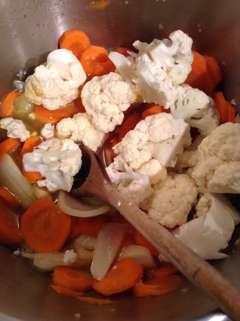 Add cauliflower and chicken broth.