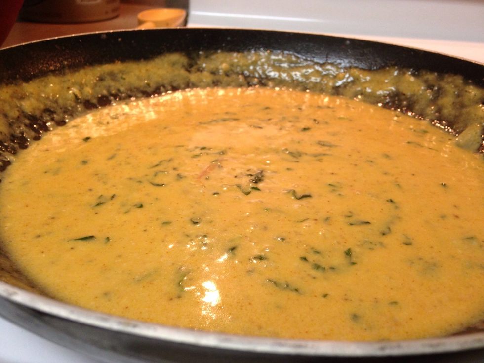 Add cayenne pepper for spice, and paprika for color. Let simmer and stir for about 3 minutes, then the add basil. Finish with Parmesan cheese, or mix it into the sauce.