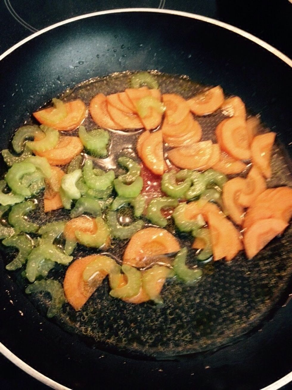 Add celery and carrot to a pan with olive oil and water