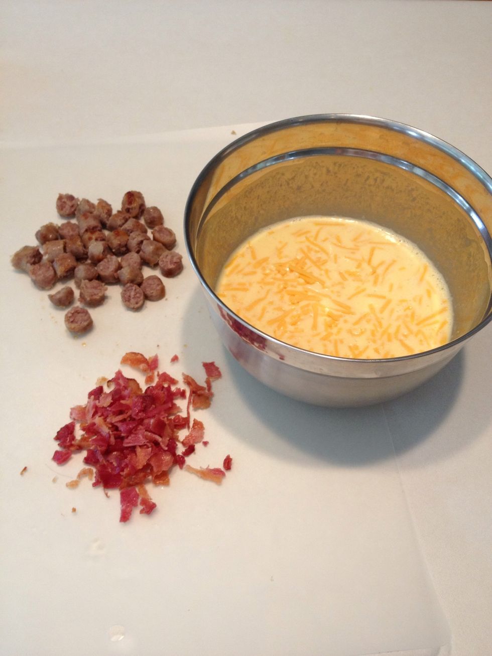 Add cheese to egg mixture. Then add any other ingredients you like. This is where you'd add the green onions if you are using them. Add salt and pepper, too. Stir well.