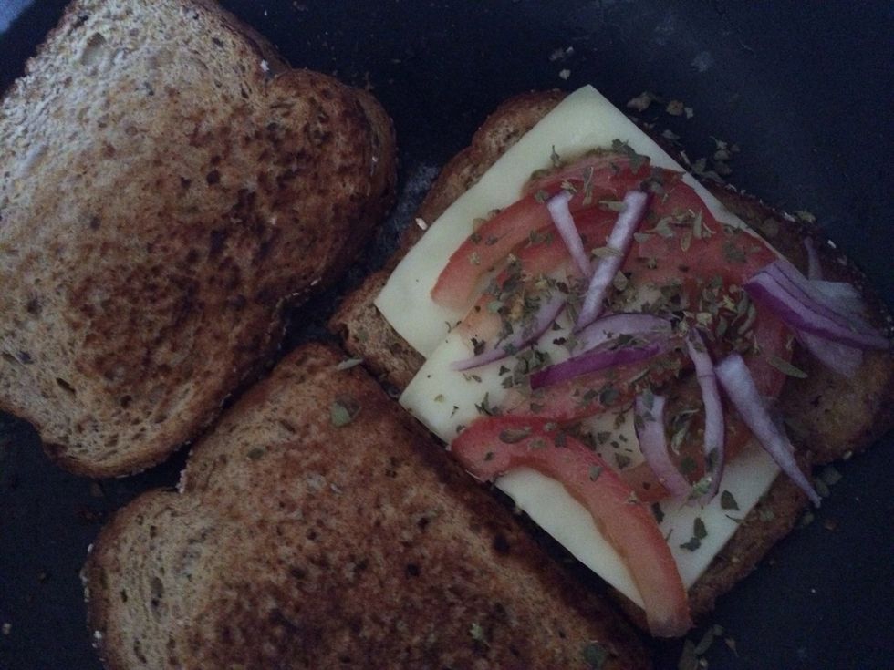 Add cheese, tomato, onion and oregano.