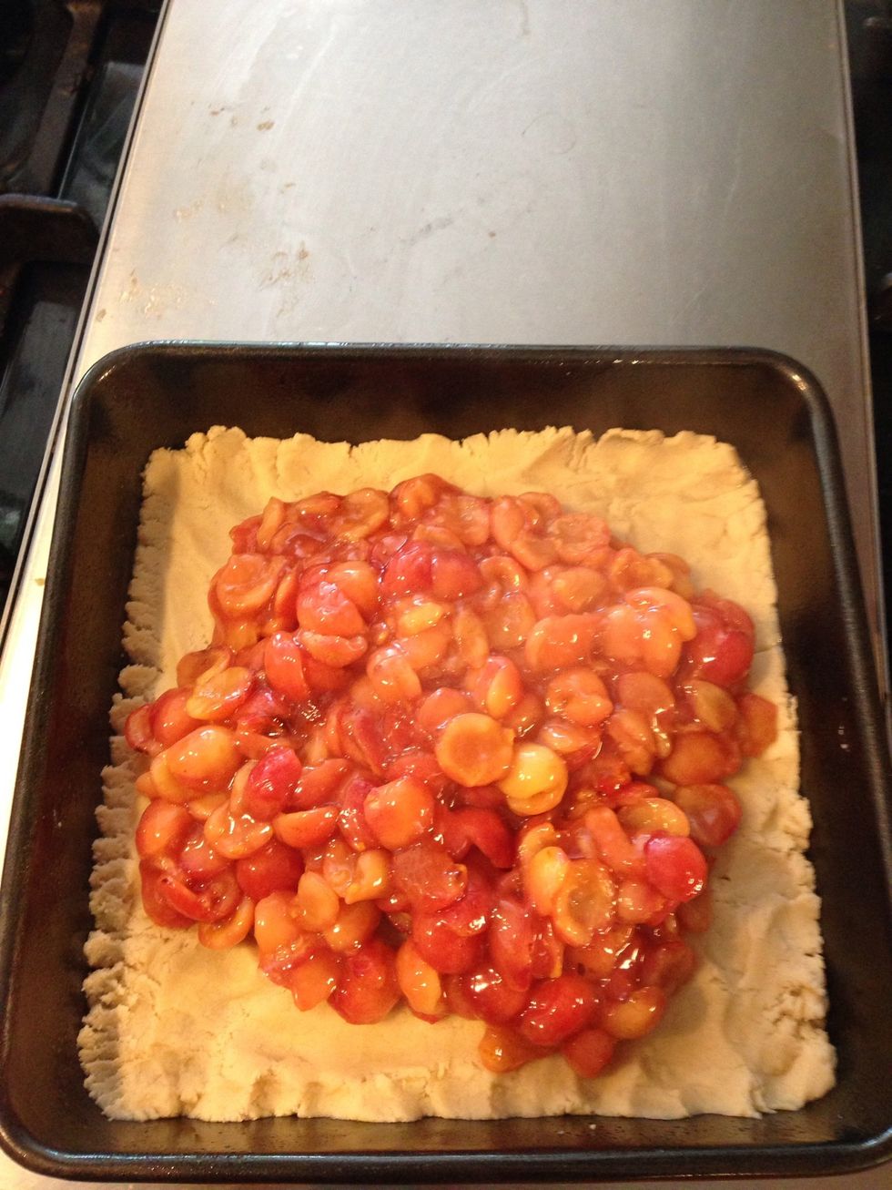 Add cherries on top. Spread it all out evenly with a rubber spatula.