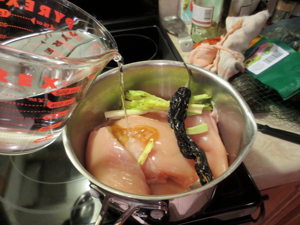 Add chicken, 1 TBL chicken bouillon, 3 cups of water, (or use stock) dried chile pepper, celery and carrot tops, (if you have them) to the other pot. Cover and boil med/high heat about 20 minutes