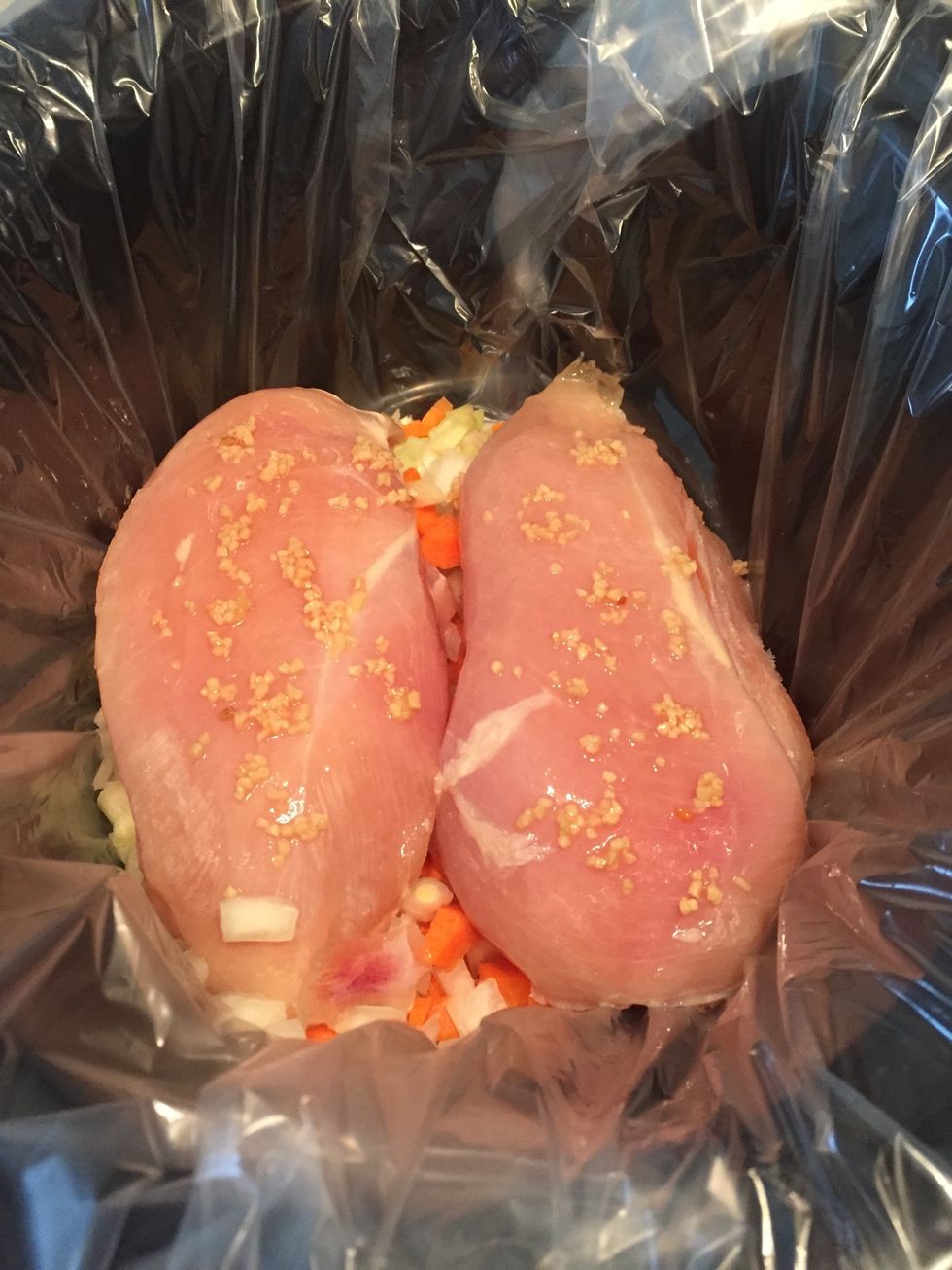 Add chicken and spread garlic on top.
