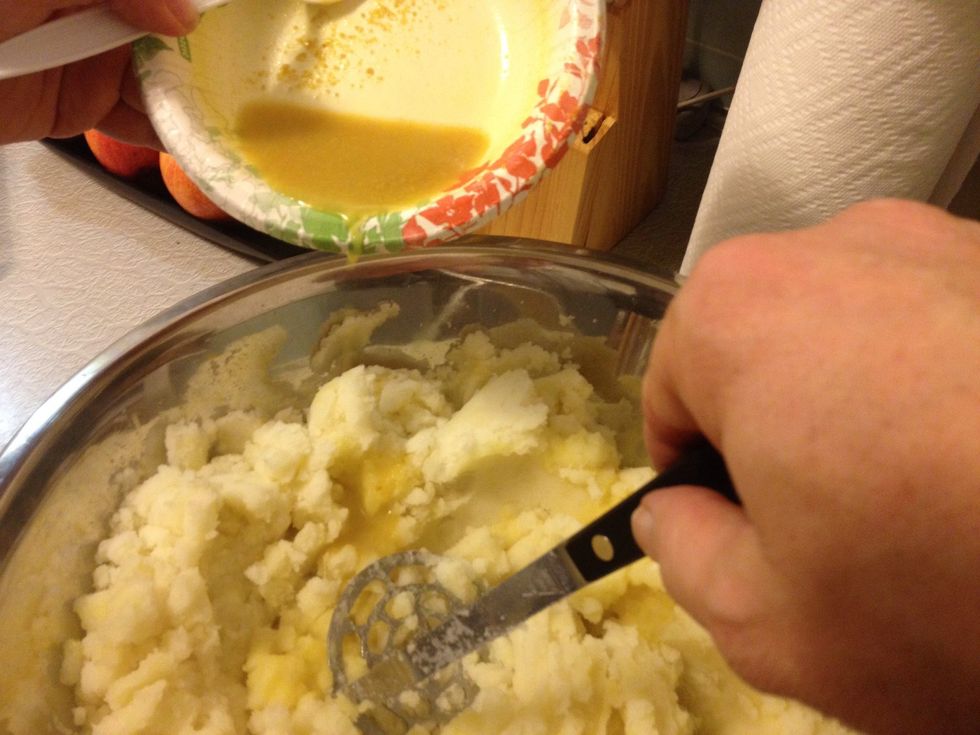 Add chicken broth or bouillon while mashing. About a tablespoon per potato. You could stop here and you would have great mashed potatoes. (My daughter says we need to add milk to make it creamy).
