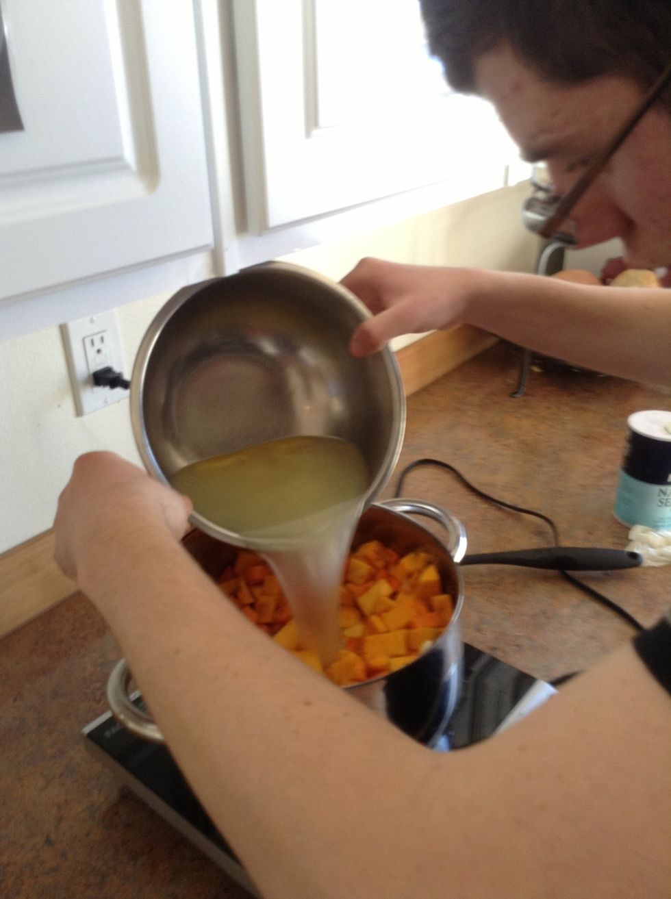 Add chicken broth to pot