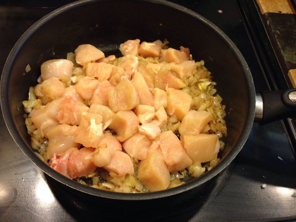 Add chicken, cook chicken and saut\u00e9 onions until translucent
