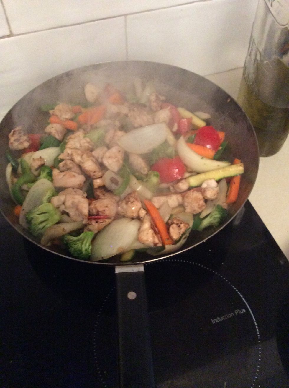 Add chicken to frying vegetables.