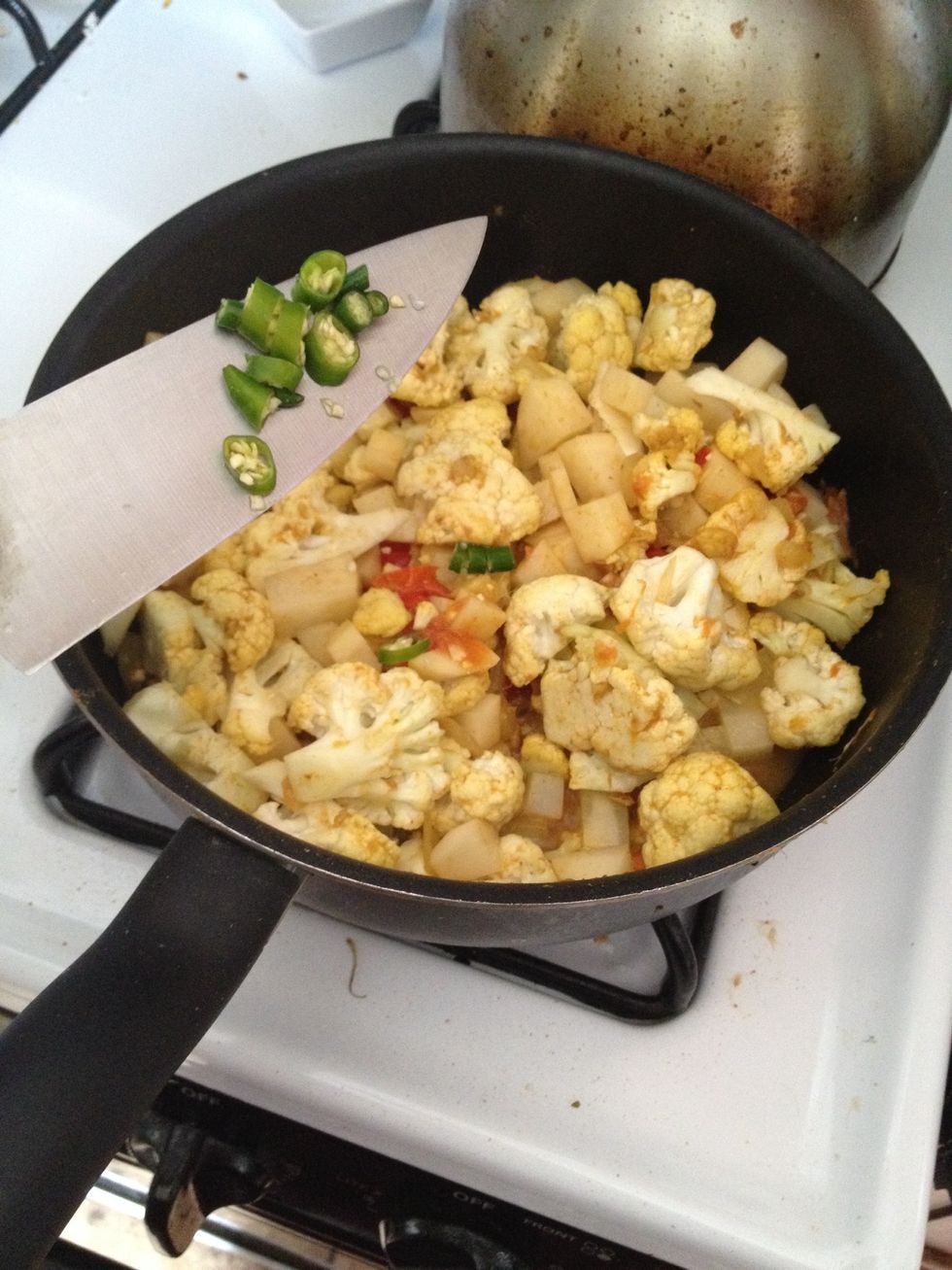 Add chilies and add a splash of water or wine vinegar to make sure the cauliflower steams properly.