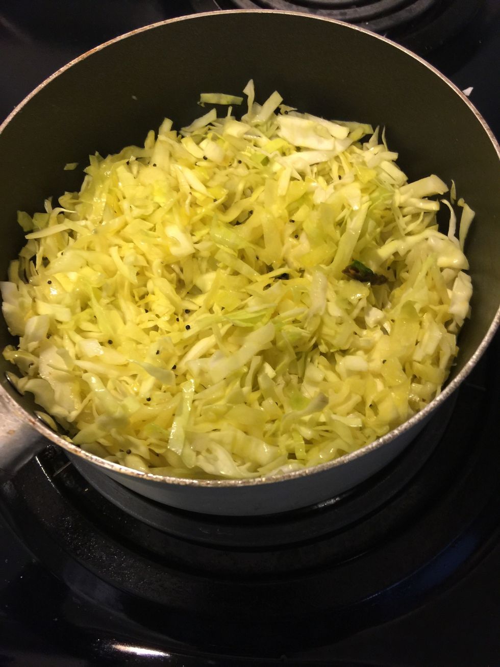 Add chopped cabbage. Put half of the chopped cabbage, mix well, then add the remaining and mix. This way the cabbage is coated well in the spices.