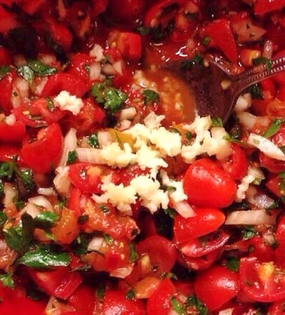 Add chopped garlic and chili fruit. Stir and add olive oil and vinegar to your liking. Finally add salt.