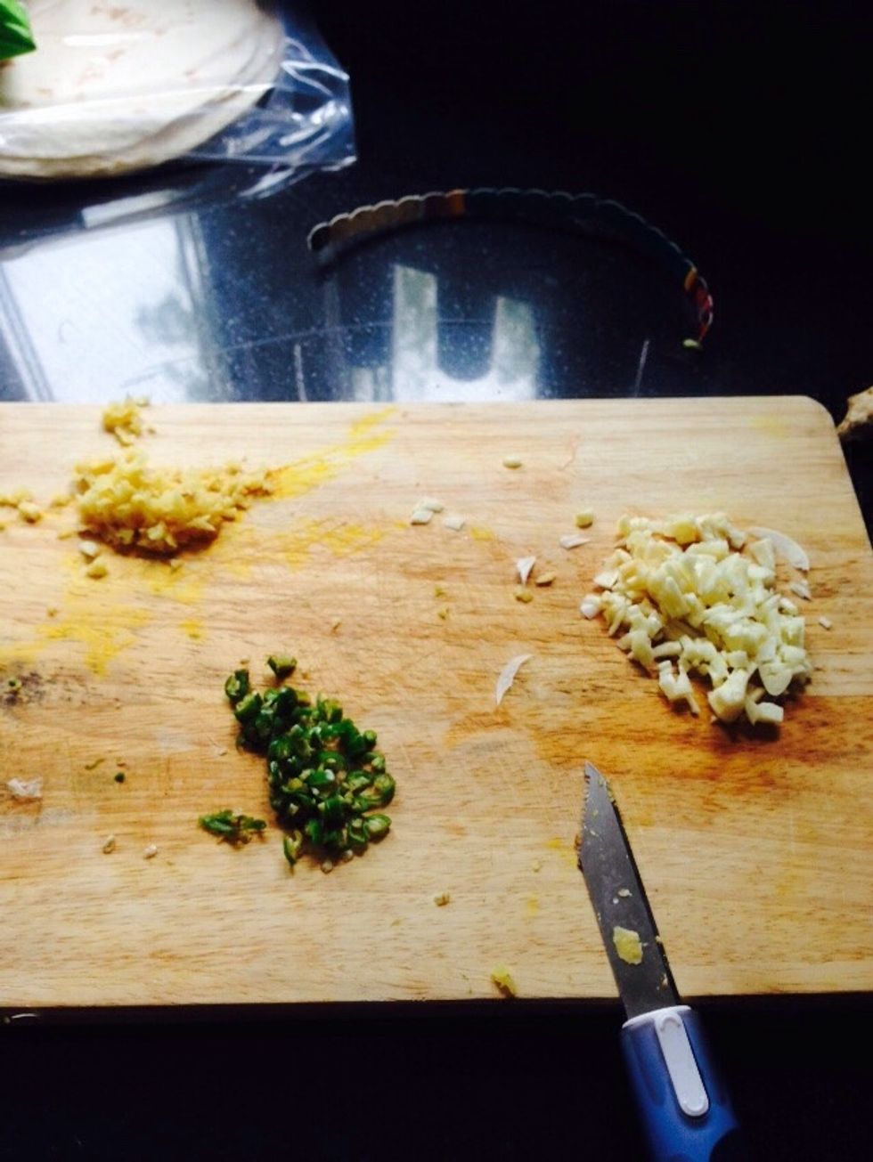 Add chopped garlic first then cook a little til brown. then add ginger + chilli - then fry