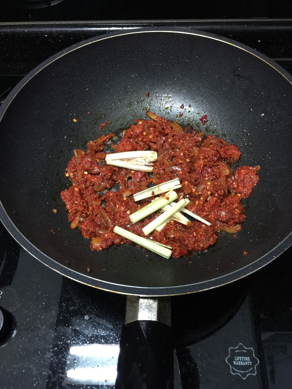Add chopped lemon grass and keep frying in medium heat until fragrance. Make sure keep stirring with your spatula as you do not want to burn the chillies.