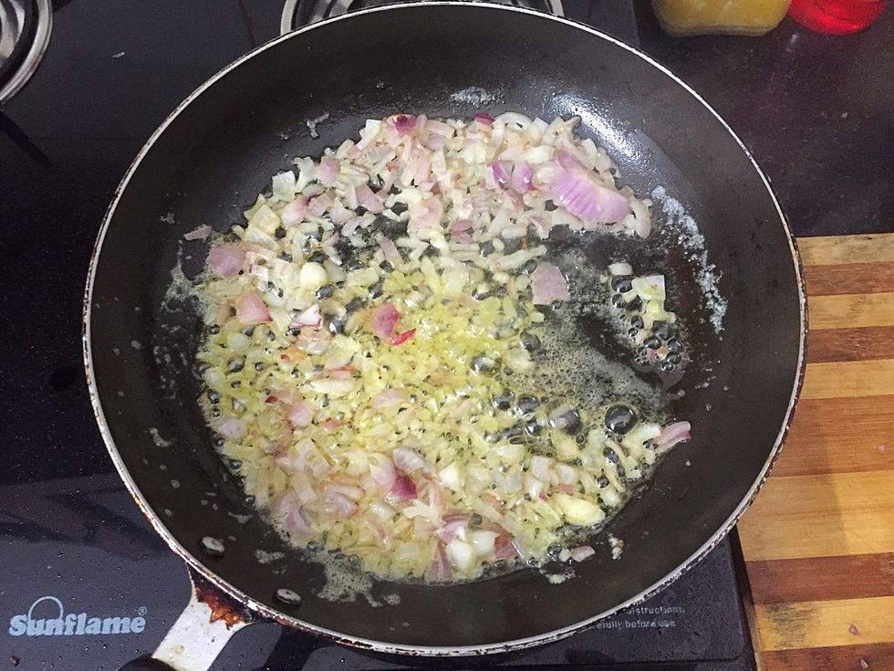 Add chopped onion and fry for 5 mins. Add garlic and fry till onion turns yellow