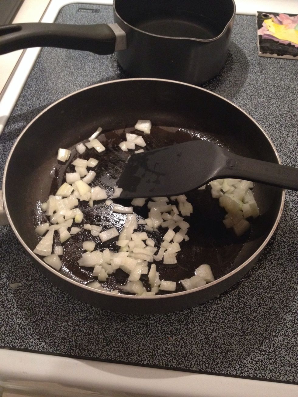 Add chopped onion to pan and stir to coat with oil.