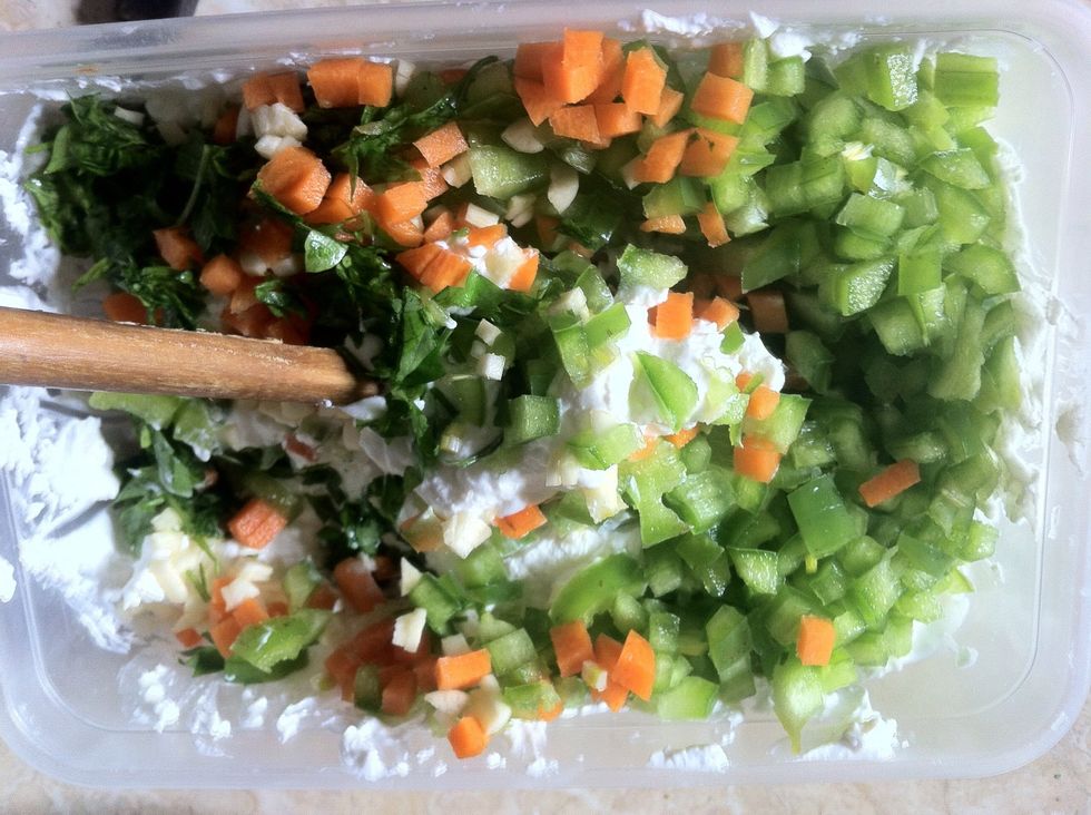 Add chopped vegetables to the cheese mixture and mix all together .