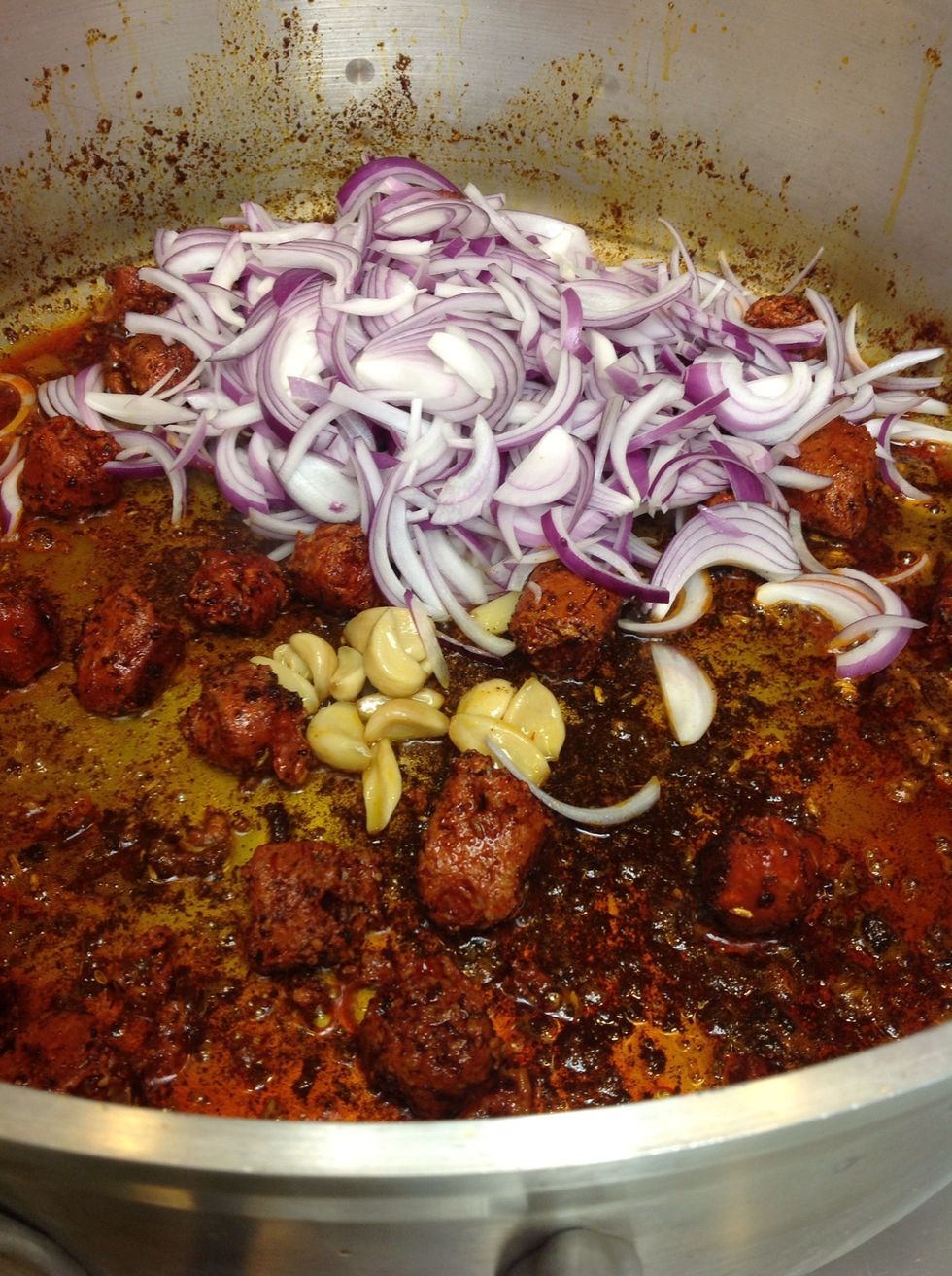 Add chorizo then the onions and roasted garlic