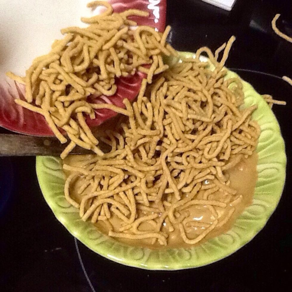 Add chow mein noodles and stir until well coated.