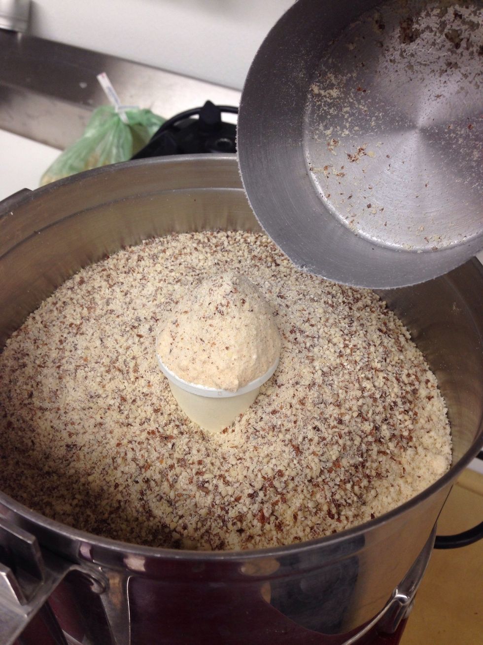 Add coconut and almond flour to a food processor.