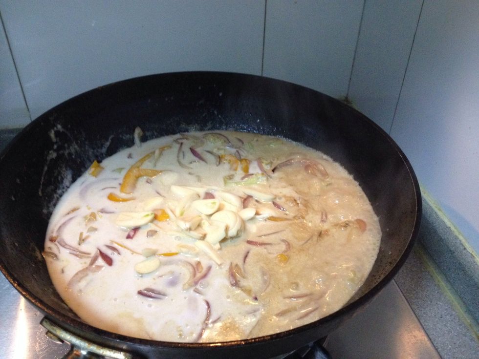 Add coconut milk and garlic slices to boil till boiling.