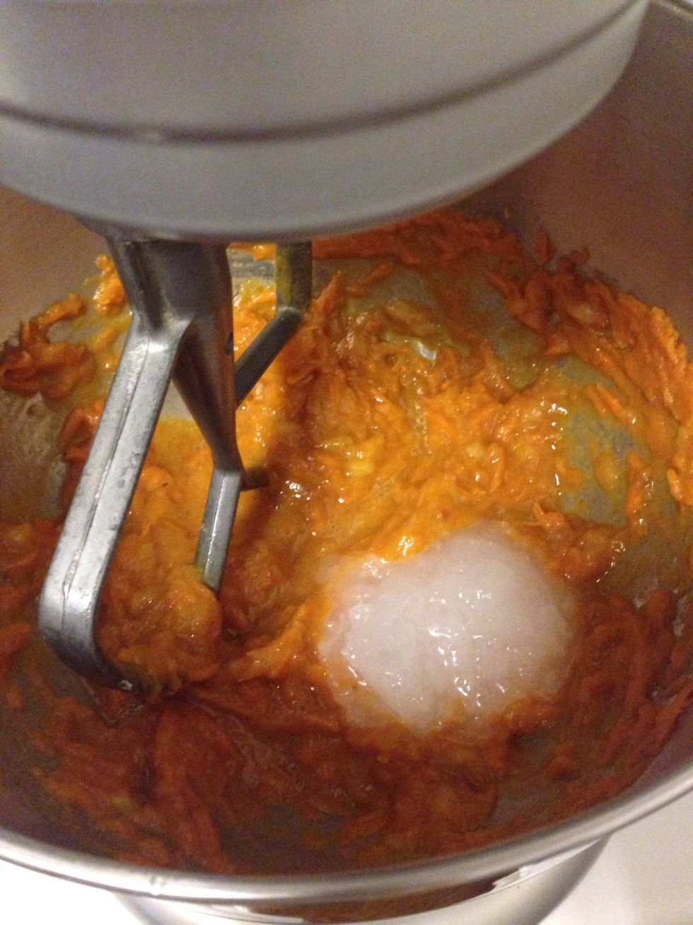 Add coconut oil to the mixture and continue stirring until combined.