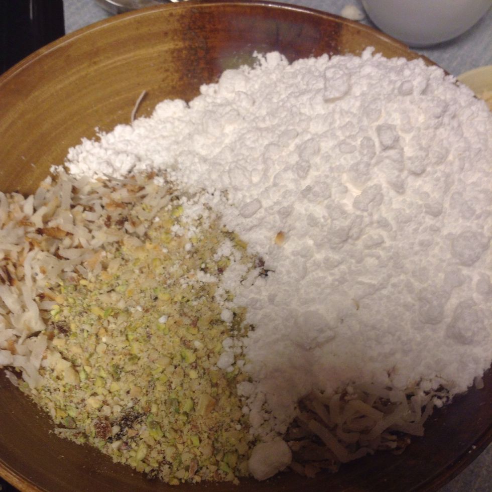 Add coconut, powdered sugar, poppy seeds, cardamom and mix of nuts together.