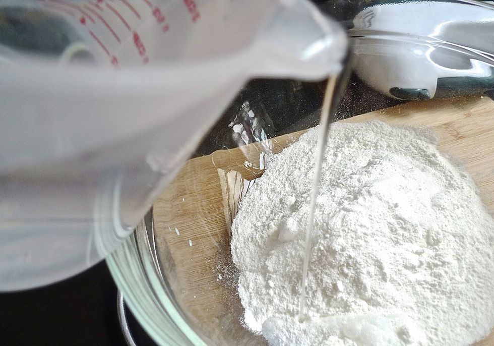 Add COLD water into the whipped topping in a stand mixer with whisk attachment.