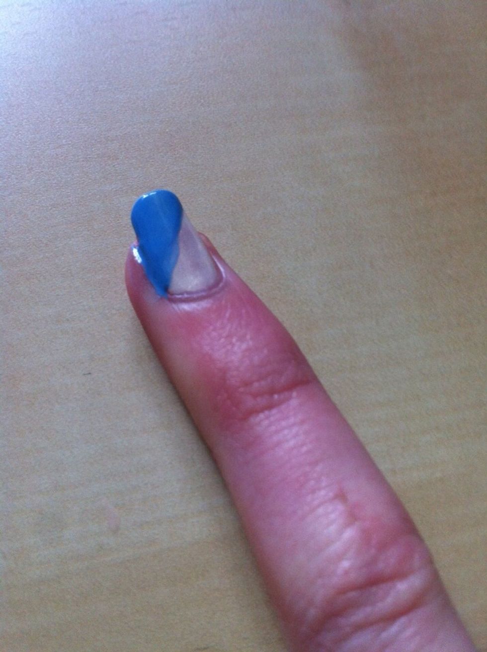 Add colour two to one half of your nail in a diagonal stroke from corner to corner. You might find you paint the skin round your nail at the same time. Just use a cotton bud to tidy up.
