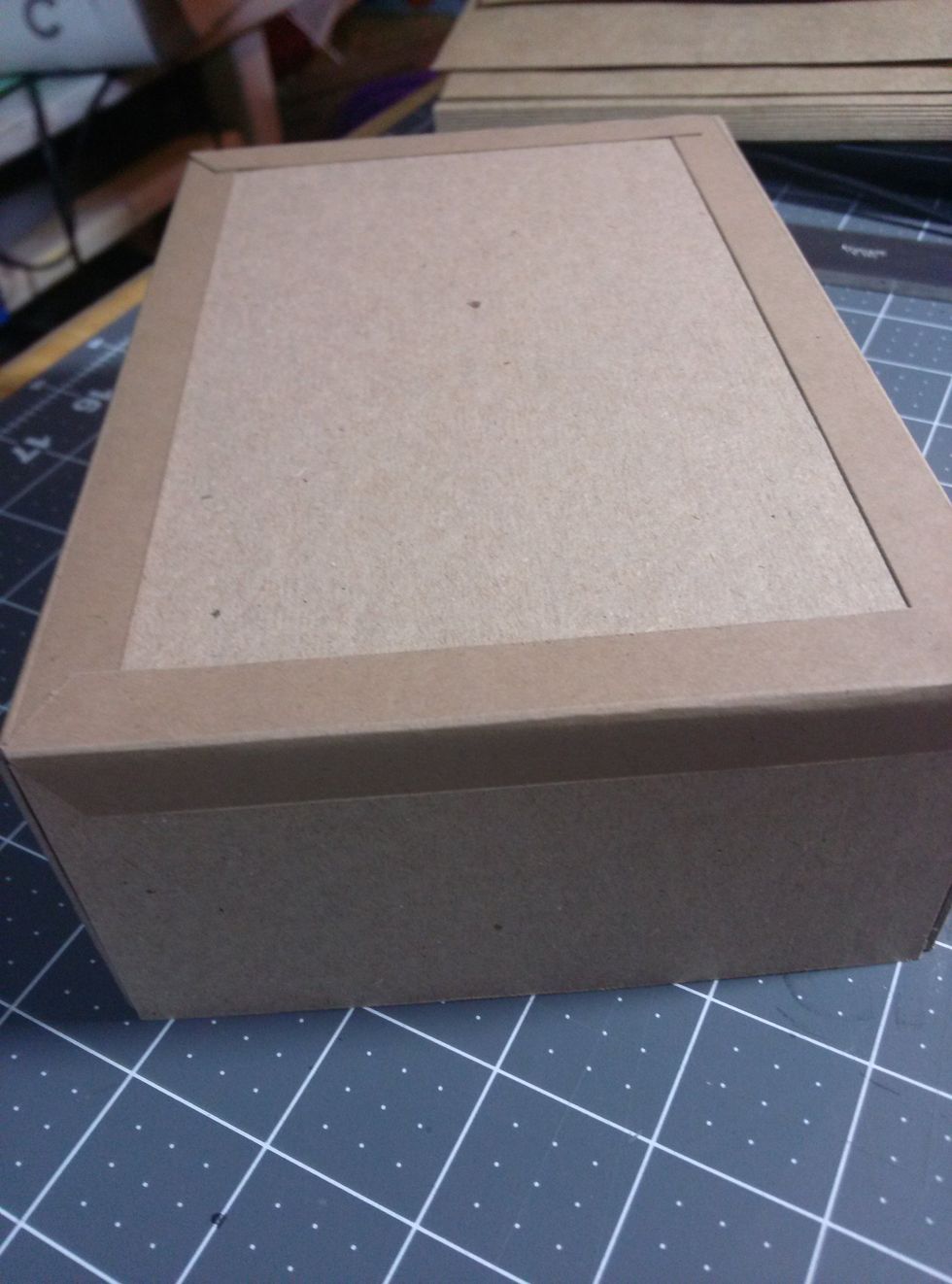 Add construction strips to cover the seams of the box on the outside of the box. Miter the corners.