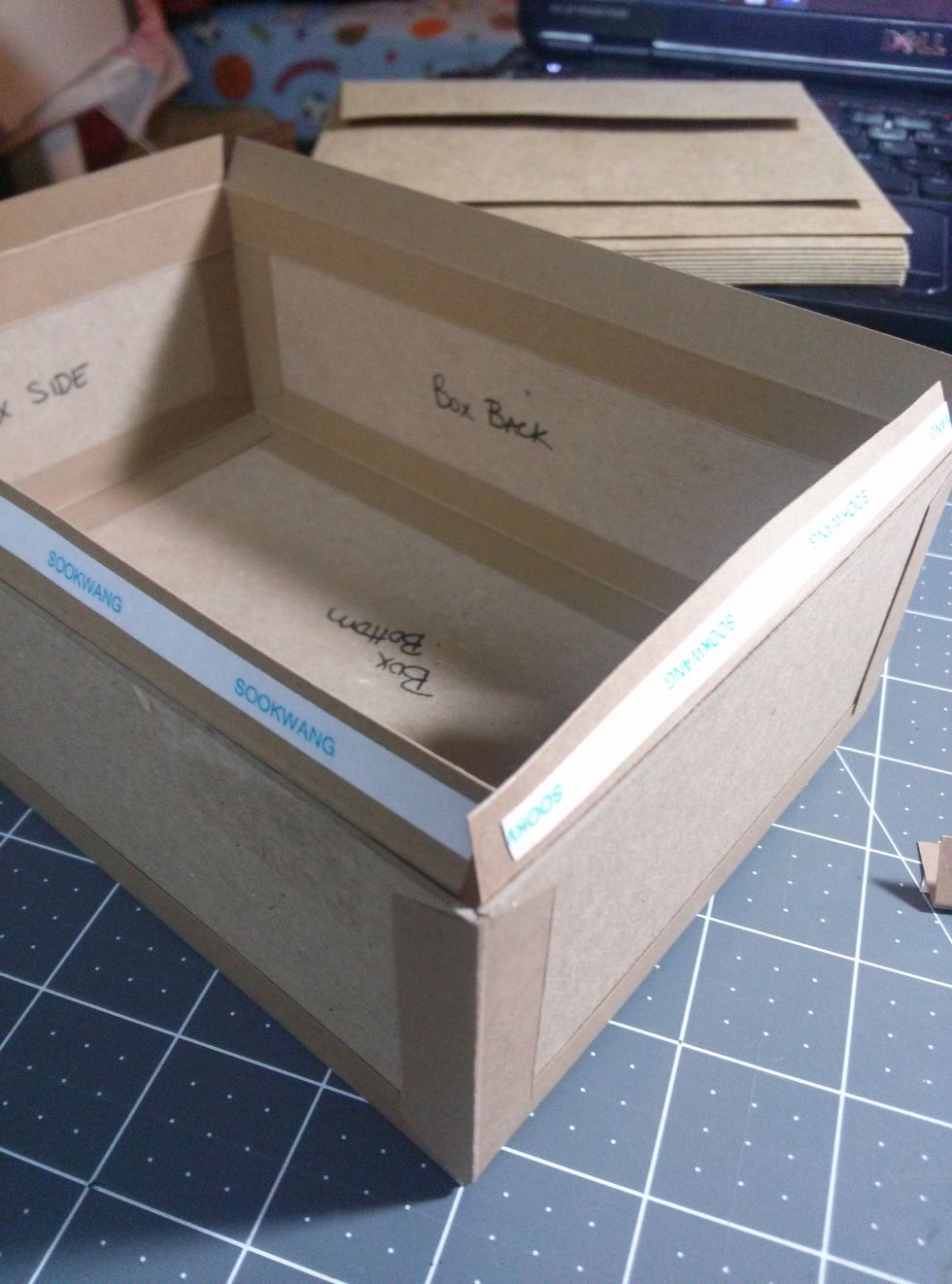 Add construction strips to the top of the box to cover the chipboard edges.