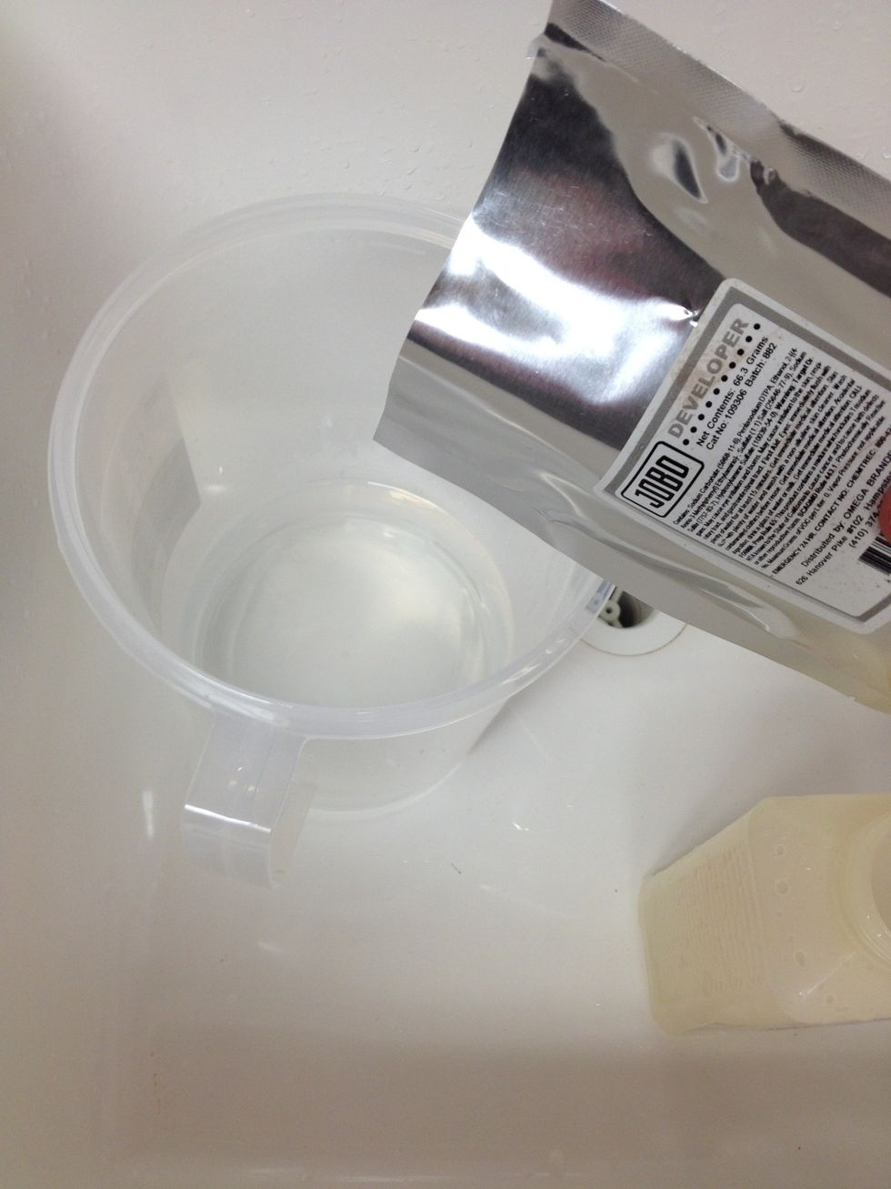 Add contents of developer packet while stirring continuously.