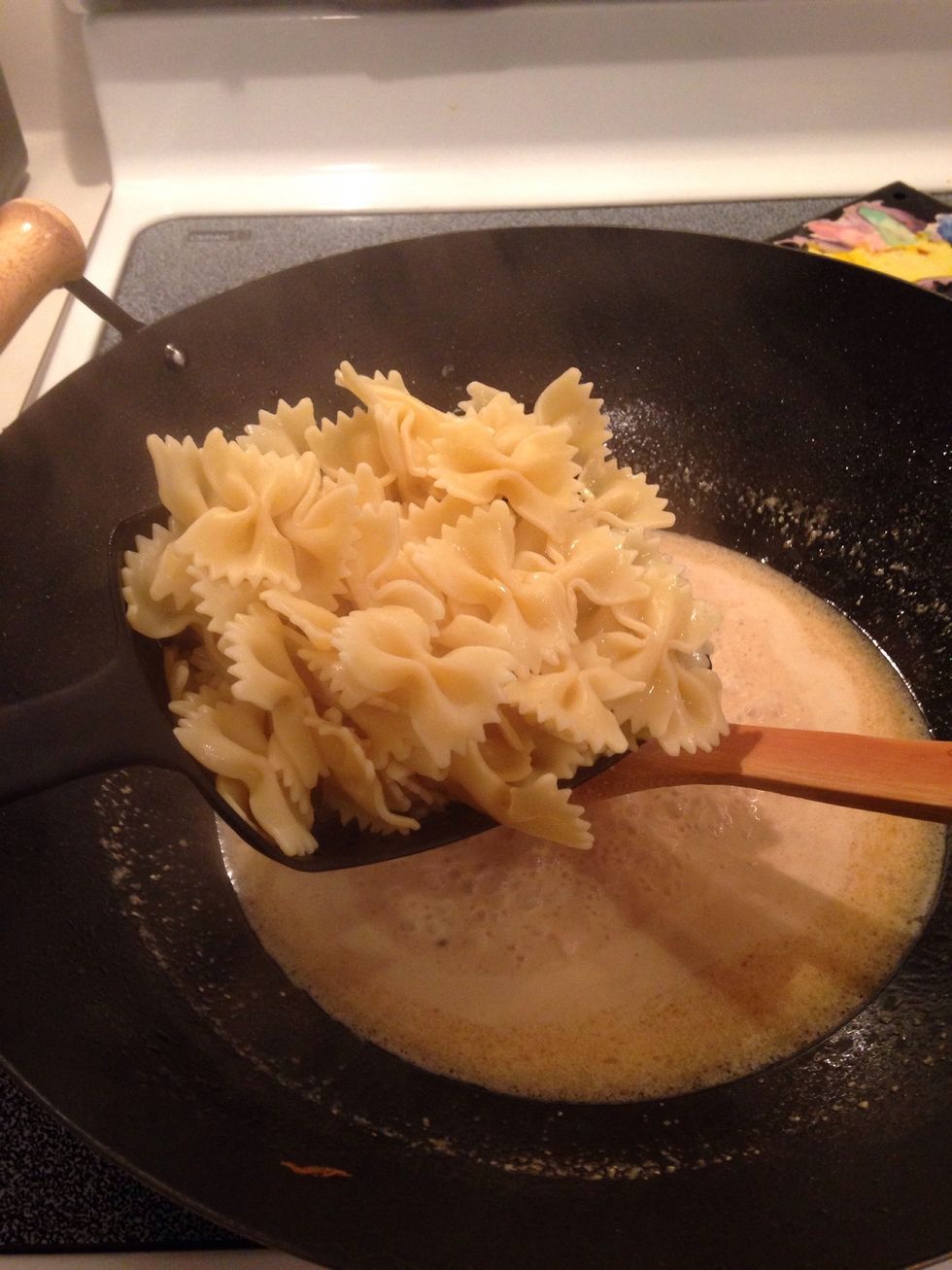 Add cooked bowtie pasta to sauce mixture.