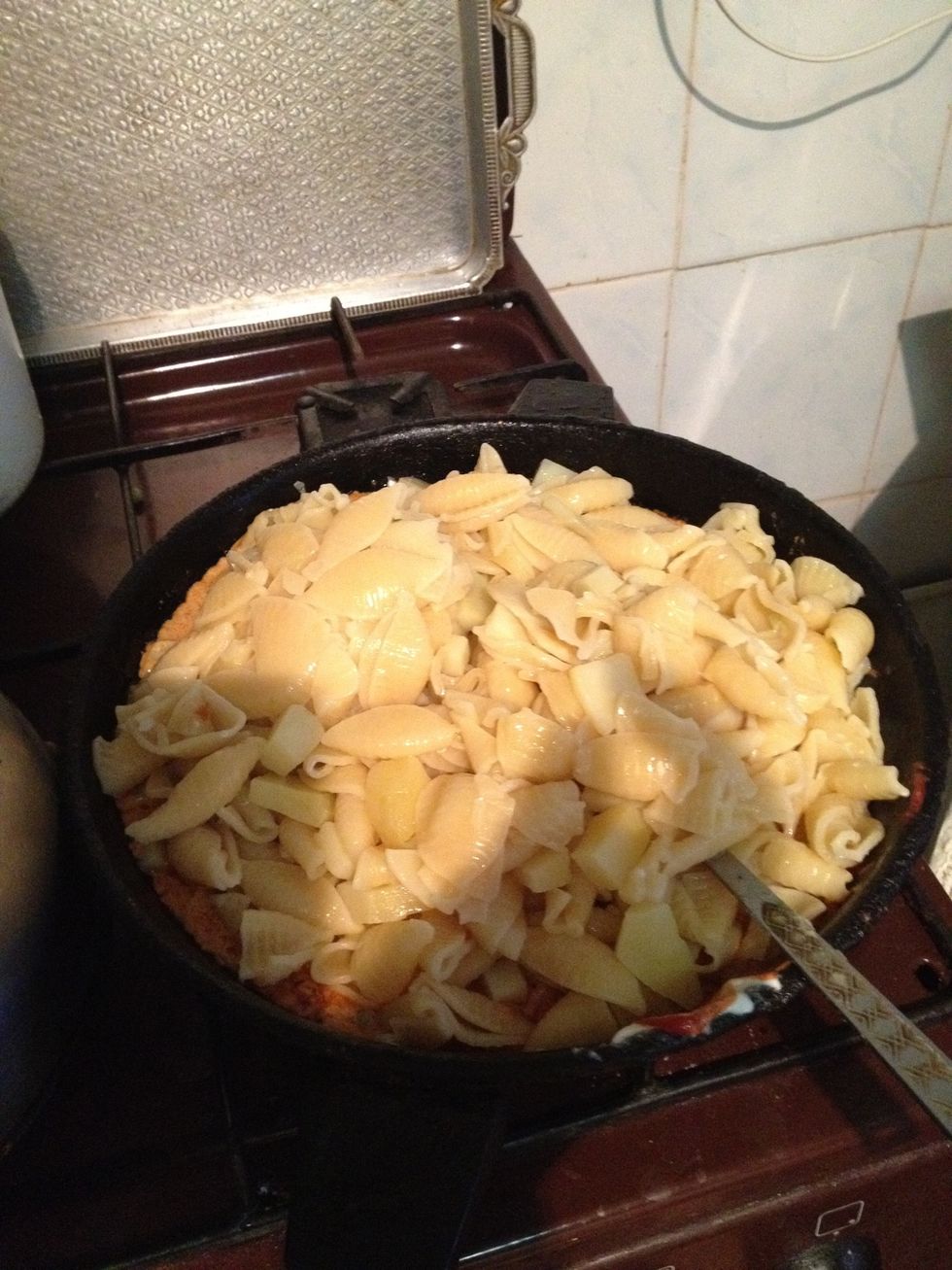 Add cooked pasta and potatoes to sauce