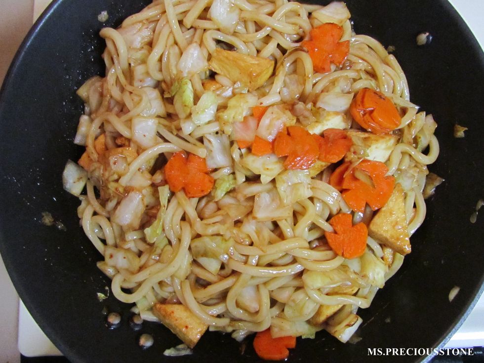 Add cooked udon noodles and sauce to the pan. Stir fry until all ingredients are covered with sauce.