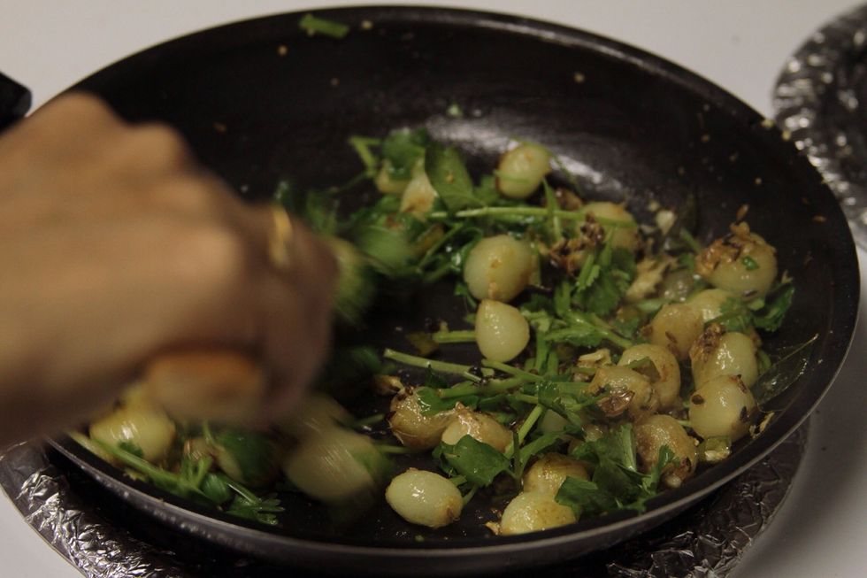 Add coriander to the pan and stir fry for 5 sec