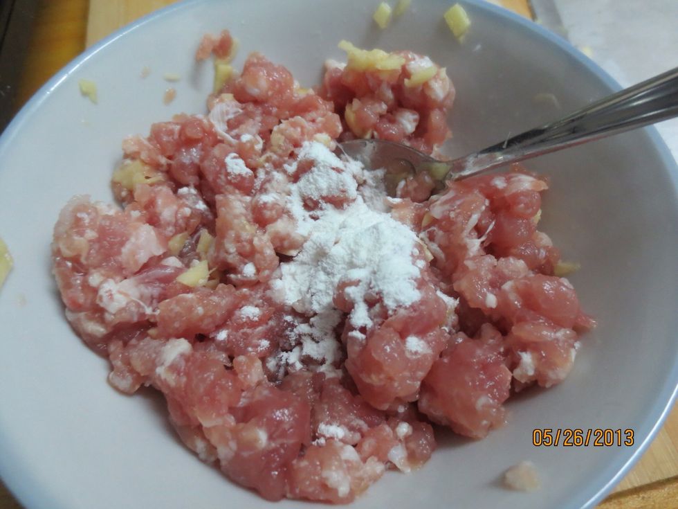 Add corn starch and cooking wine into the ground pork. Mix and marinate for ten minutes.
