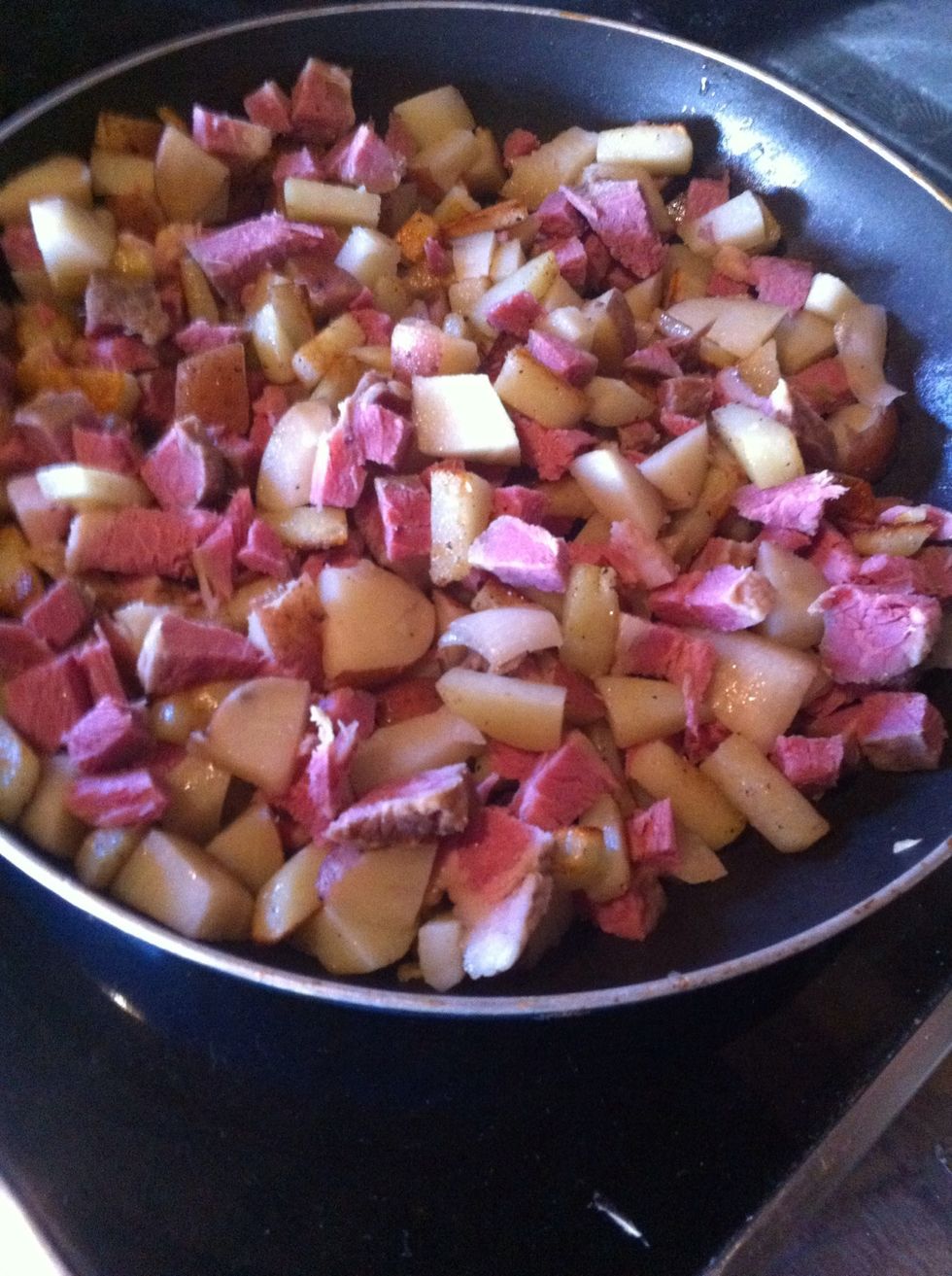 Add corned beef..fry for a few minutes more until the meat is hot. Stir frequently to heat evenly.