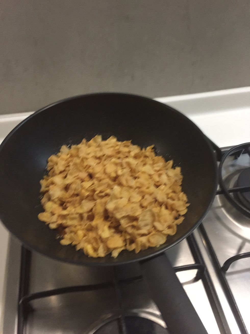 Add cornflakes and quickly toss with two heat proof spatulas. (Be quick!) when it's evenly coated add nuts and fruits. Toss!