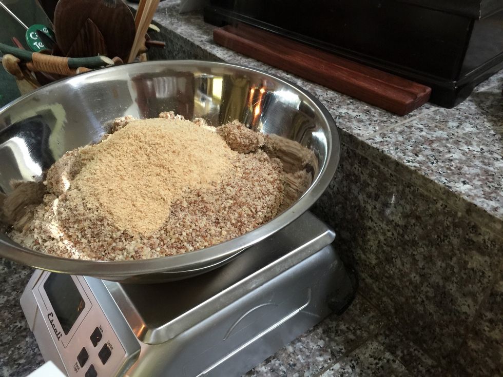 Add cracker crumbs to ground nuts. We use Pecan Meal. It's just as good and about 1/10th the cost of buying and grinding pecan pieces! I'll put a source in "Comments"