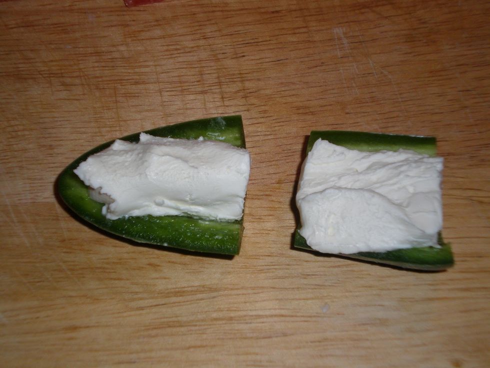 Add cream cheese to the inside of the jalapeno, about a spoonful.