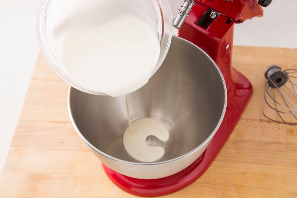 Add cream to a large bowl fitted to a stand mixer.