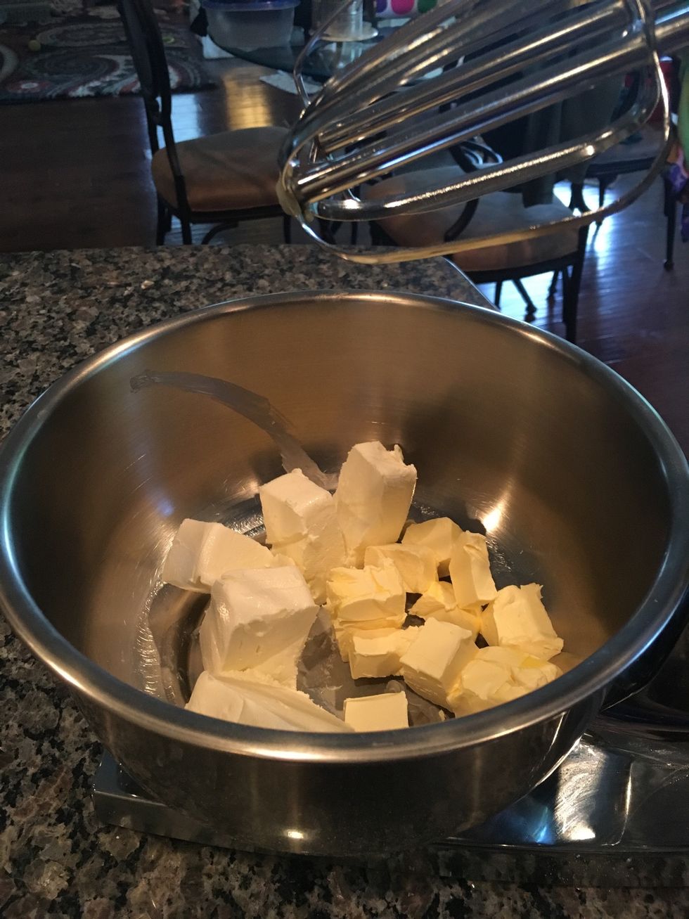 Add cubes of cream cheese and butter into the mixing bowl.