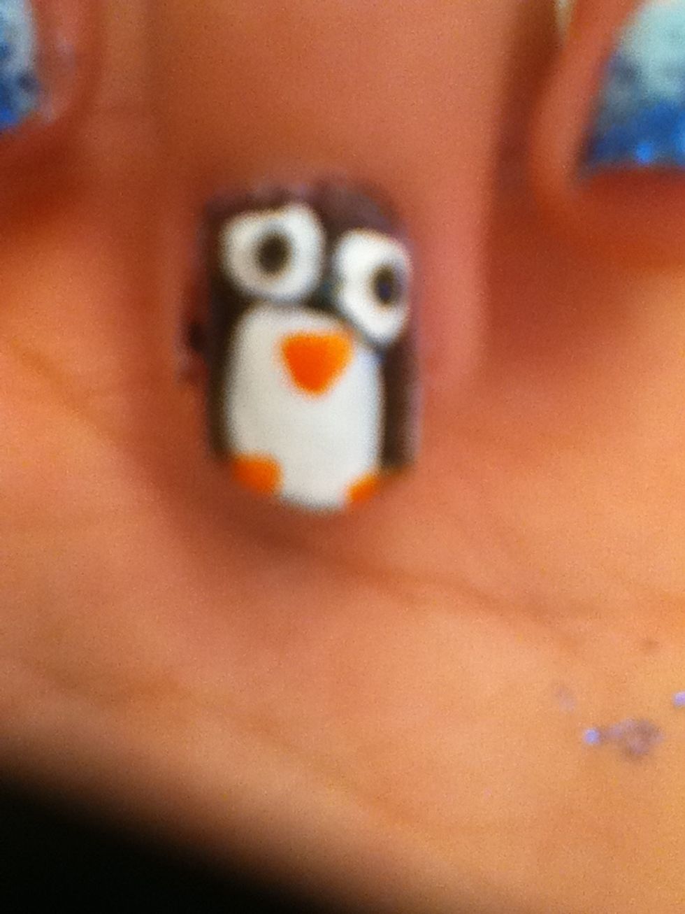 Add cute black pupils in the middle of the white circles and add triangle nose and little ovals at bottom for our little penguin's feet! How cute is he? I need to give it a name! How about... Steven!