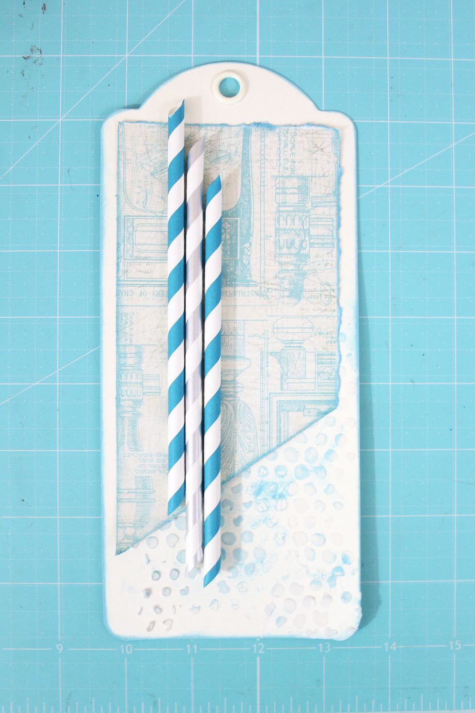 Add decorative straws just to the left of the center of the tag.