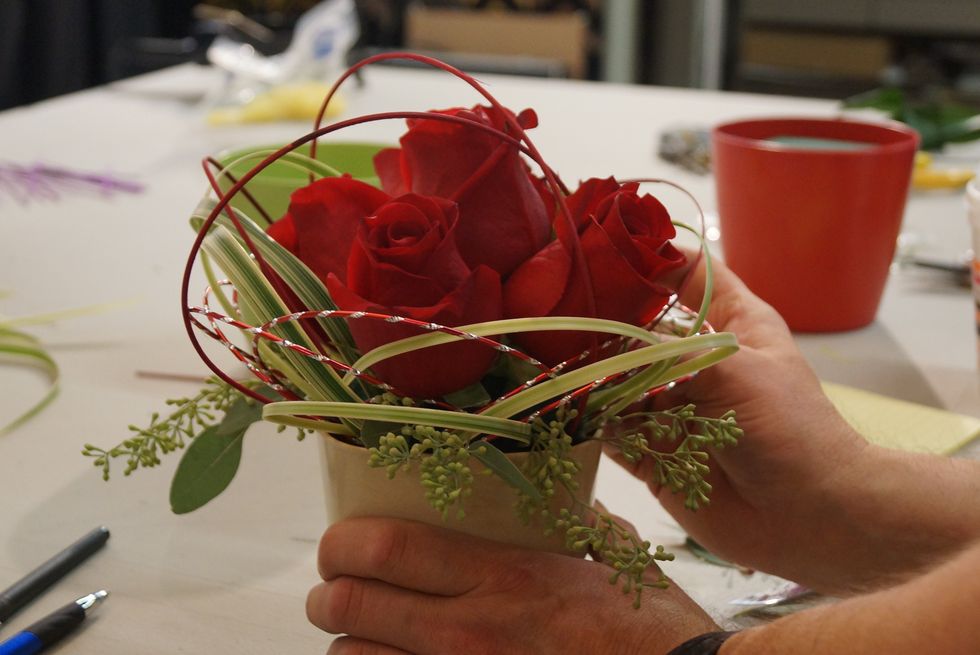Add desired flower (in this case, roses) and finish with Midollino Sticks in coordinating color