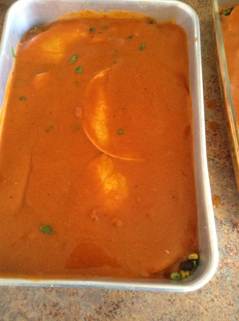 Add divide sauce over both baking dishes