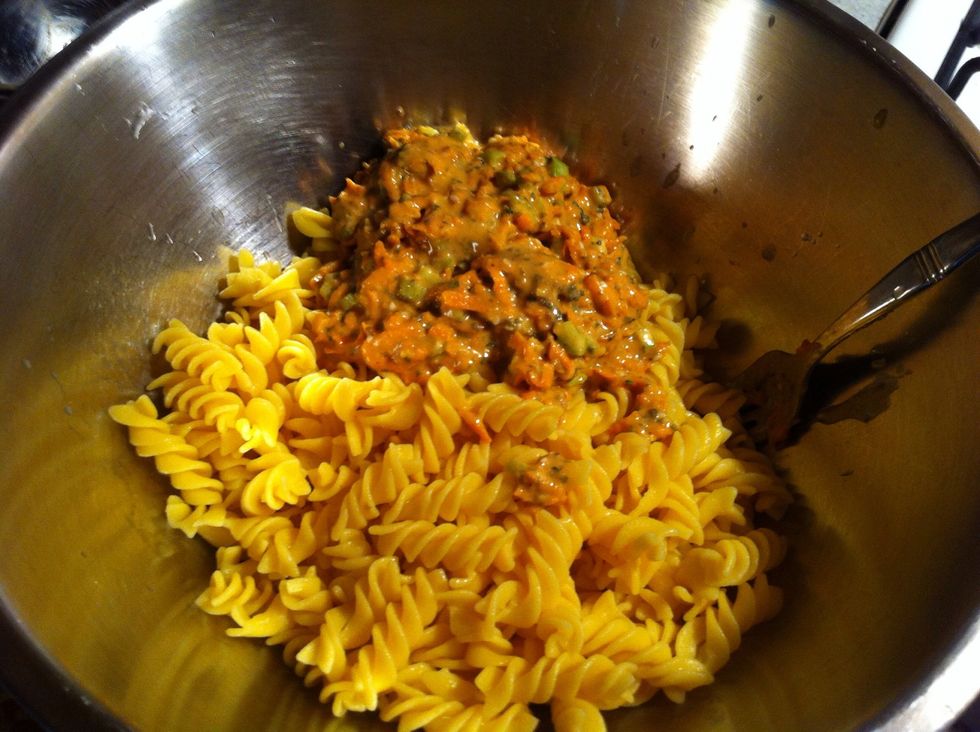 Add dressing and again mix evenly to cover all pasta... Then place into frig or freezer to cool for a short time...