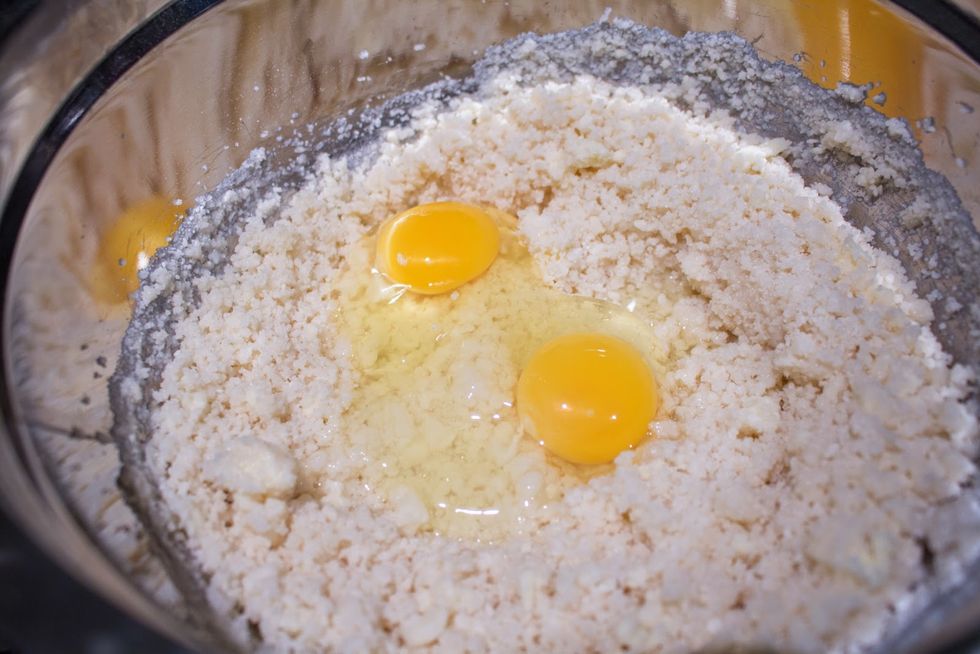 Add eggs to the crumbly mixture. 